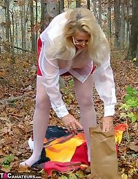 Horny granny Adonna removes her panties and toys herself in the woods
