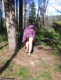Fat granny Girdle Goddess loses her purple outfit in the woods and poses nude